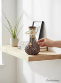 Go Hooked brown painted glass flower vase with textured pattern and decorative twine accent.