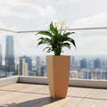 GoHooked brown 18-inch tall polymer planter with a peace lily plant on a balcony.