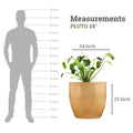 Go Hooked 24-inch round brown polymer planter with a monstera plant. Shows scale against a silhouette of a person.