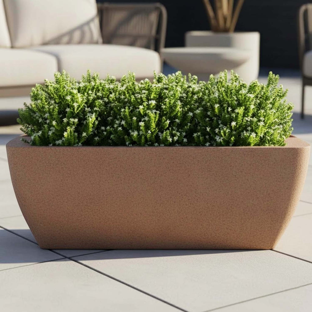 GoHooked brown rectangular polymer planter filled with lush green foliage on a modern outdoor patio.