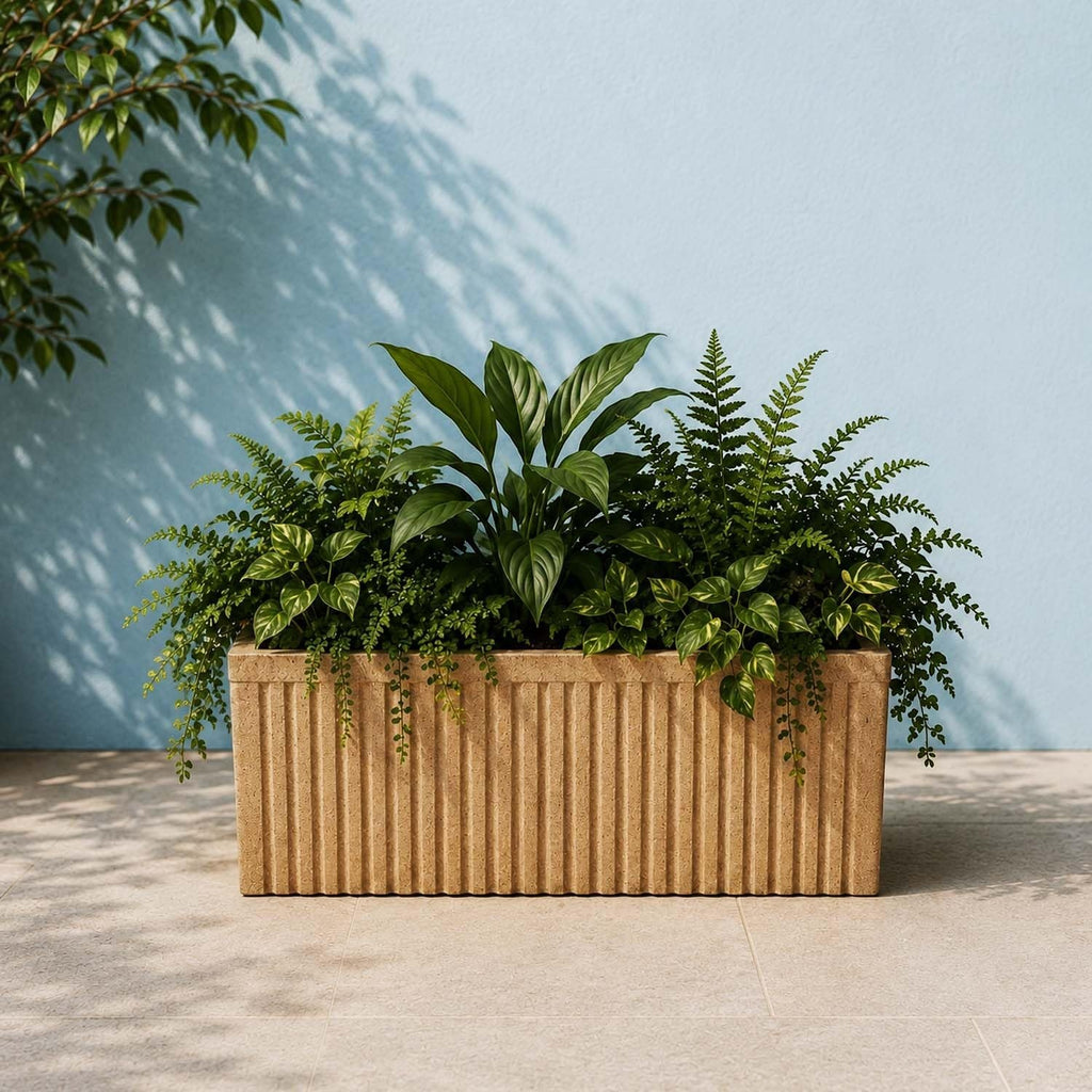 GoHooked brown sandstone ribbed polymer rectangular planter pot filled with lush green plants.
