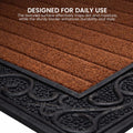 GoHooked brown rubber door mat with a ribbed surface and decorative black scrollwork border for dirt trapping.