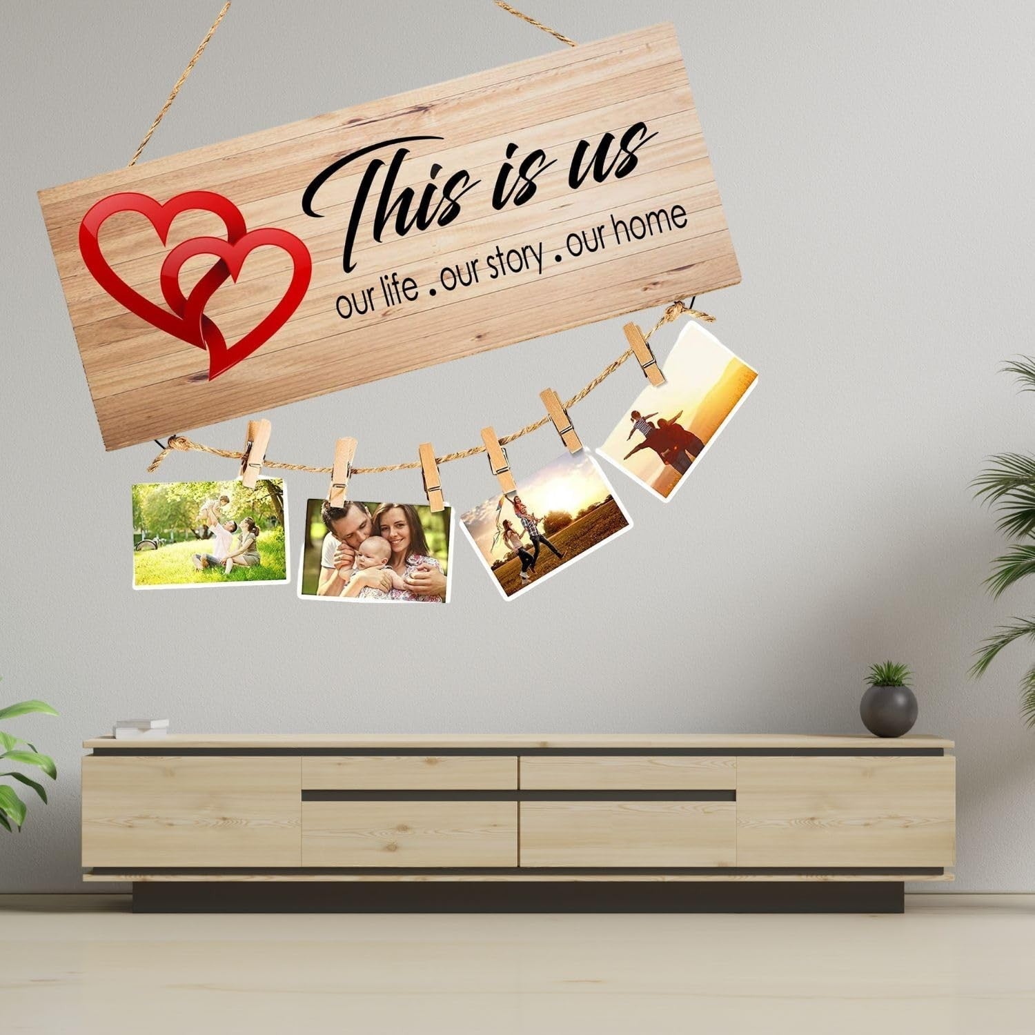 GoHooked brown MDF wood "This is us" sign with red hearts and twine for hanging photos. Rustic farmhouse decor.