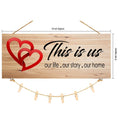 GoHooked brown MDF wood sign with two red hearts and "This is us our life. our story. our home" text, includes twine and clips for photos.