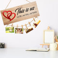 GoHooked brown MDF wood sign with "This is us our life . our story . our home" and red hearts, holding photos with clips.