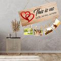 GoHooked brown MDF wood sign with red hearts and "This is us" quote, holding photos with clips and twine.