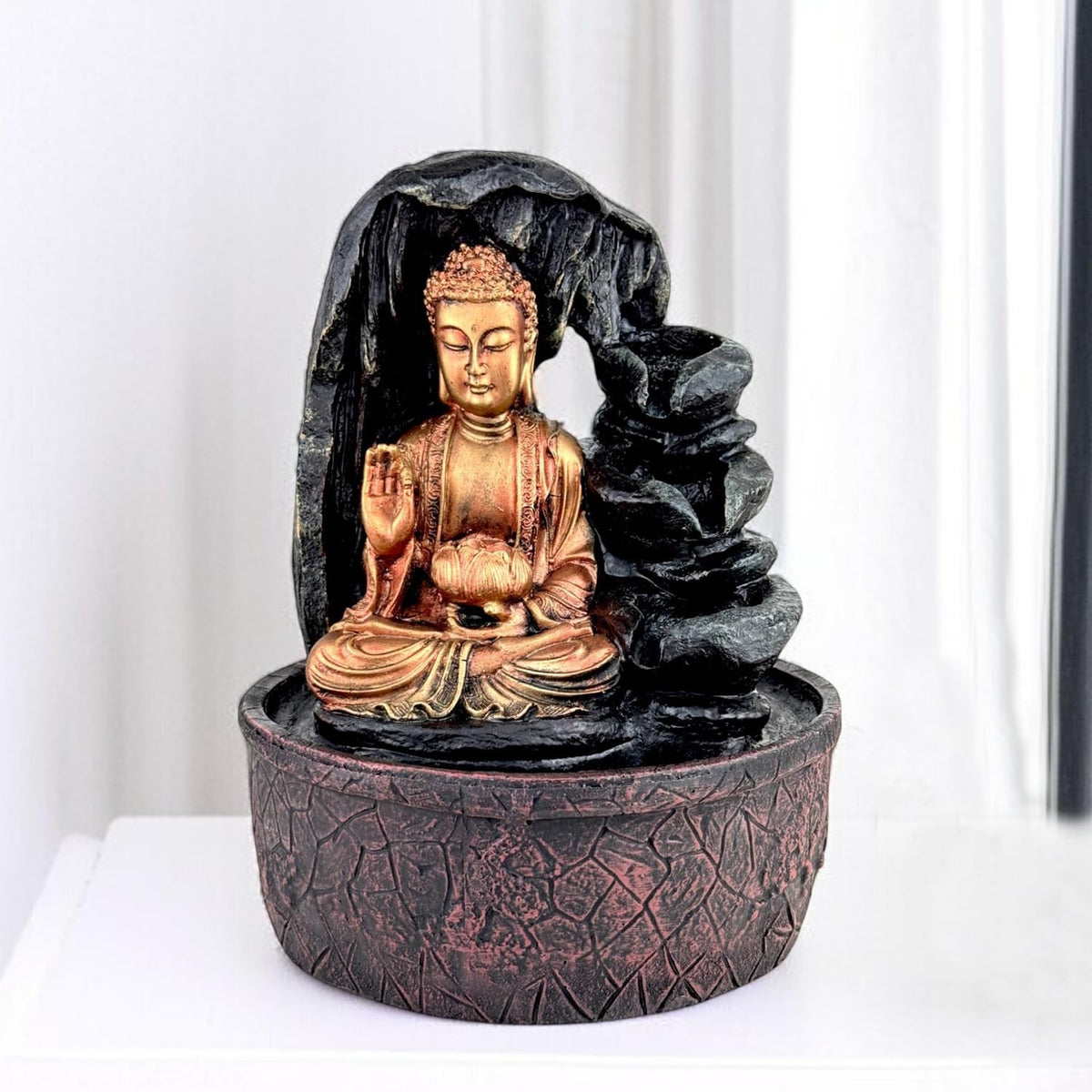 Go Hooked multicolor polyresin Buddha fountain with LED light and cascading waterfall effect. Ideal for meditation and home decor.