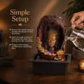 Go Hooked multicolour polyresin Buddha face tabletop fountain with LED light and water pump. Textured rock design.