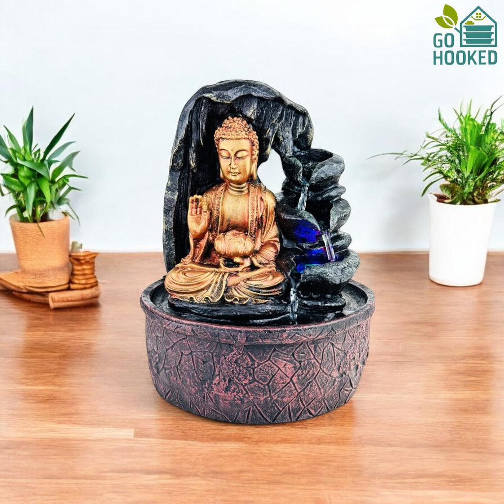 Go Hooked golden Buddha fountain with cascading water and blue LED lights, made of polyresin. Ideal for meditation and home decor.