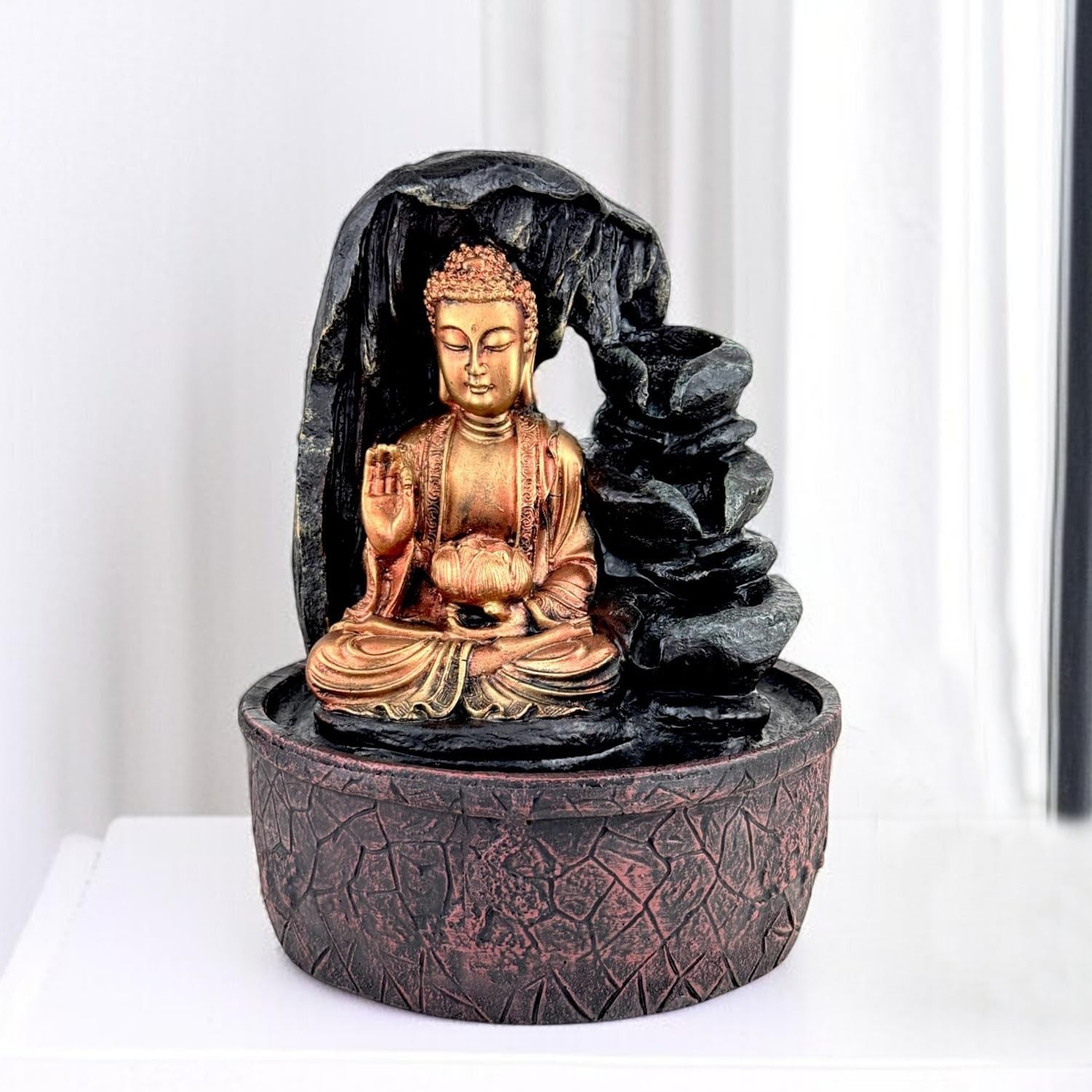 GoHooked Lord Buddha tabletop fountain with LED lights, adjustable water flow, and polyresin construction. Features a meditating Buddha figure with a lotus flower.