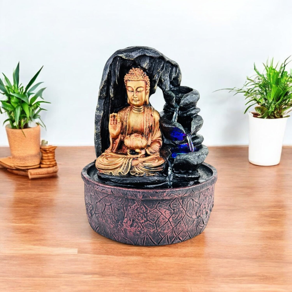 GoHooked Lord Buddha tabletop fountain with LED lights and adjustable water flow, made of polyresin in bronze and black.