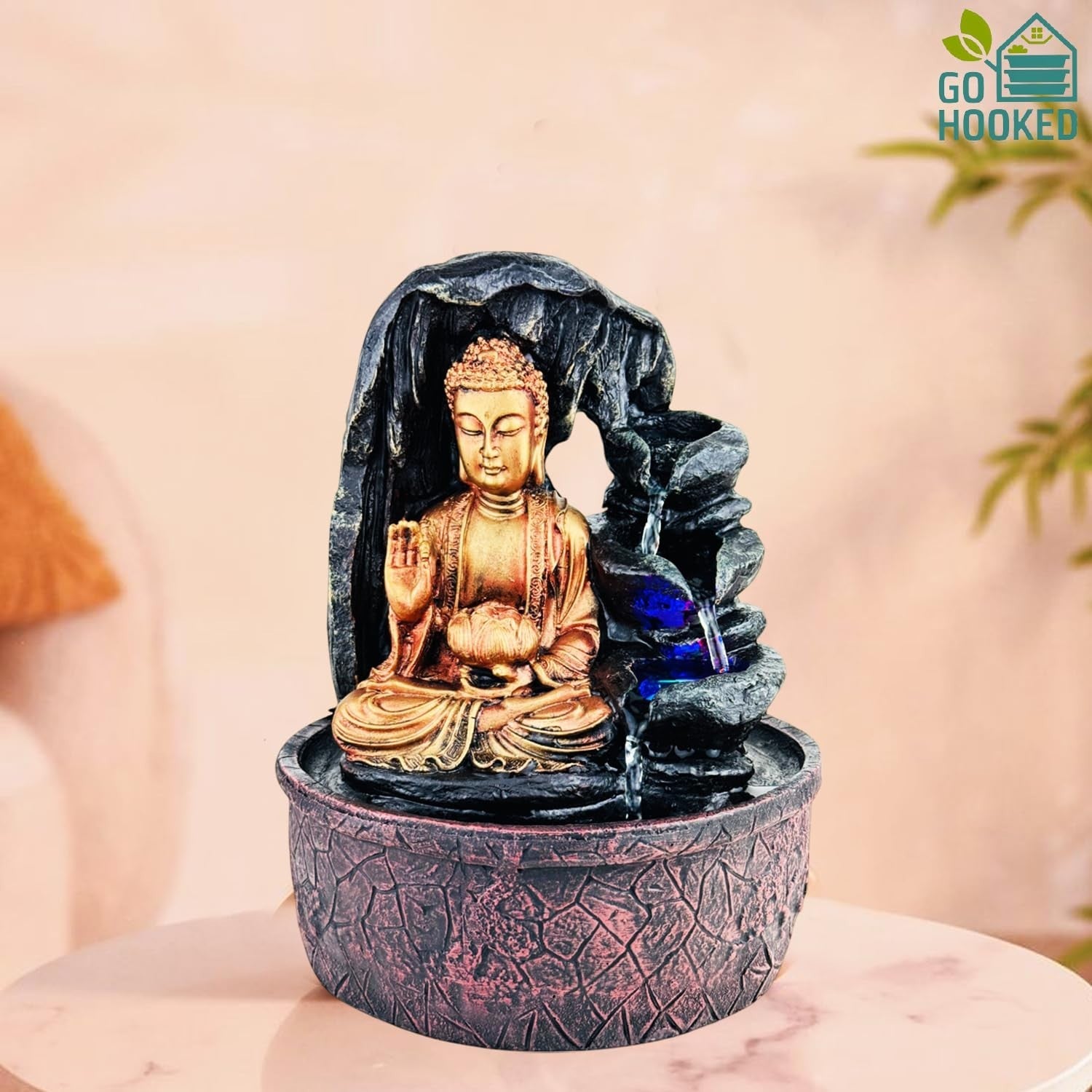 Go Hooked golden Buddha fountain with cascading water and blue LED lights, made of polyresin.