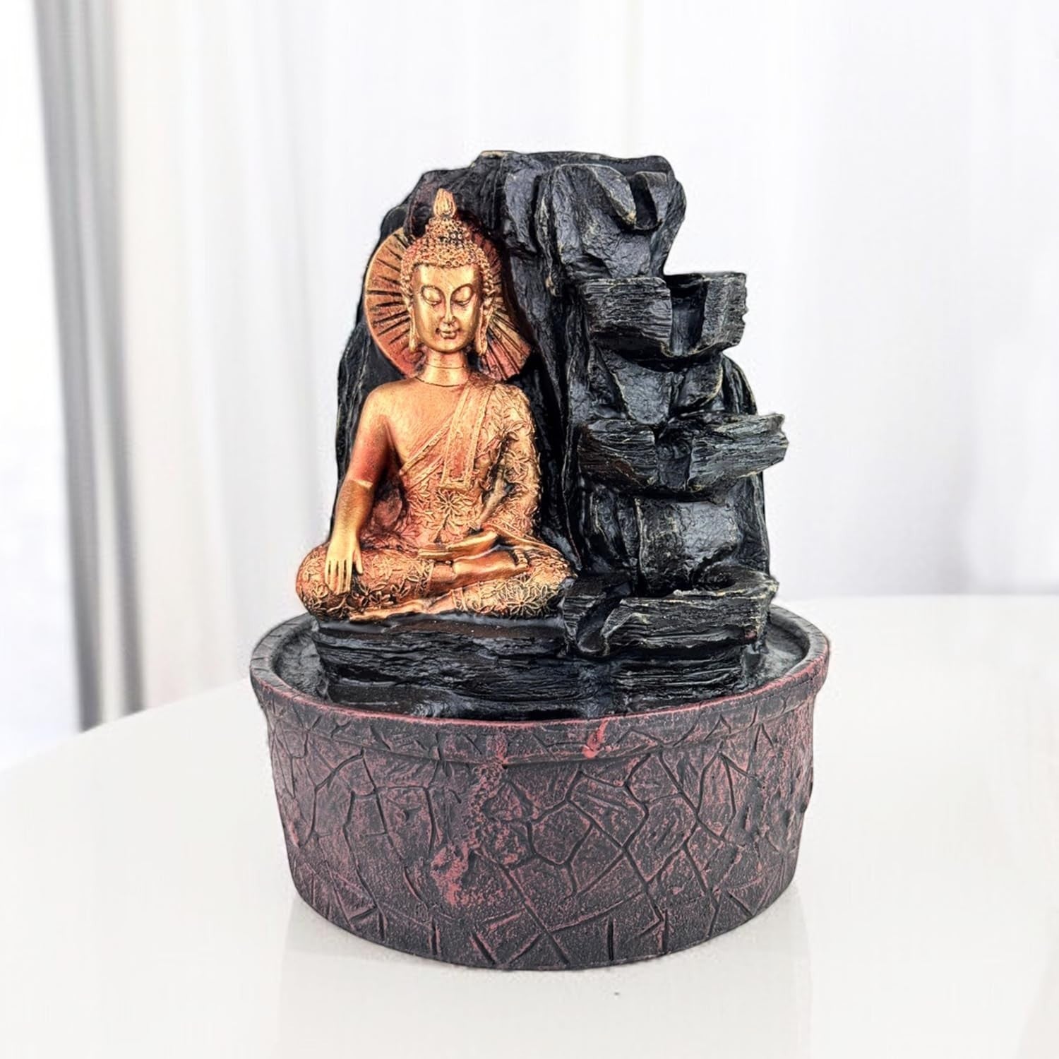 Go Hooked Lord Buddha resin tabletop fountain with cascading water and LED lights, ideal for meditation and home decor.