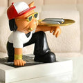 GoHooked black and white polyresin bulldog statue holding a gold tray, wearing sunglasses and a red and white cap.