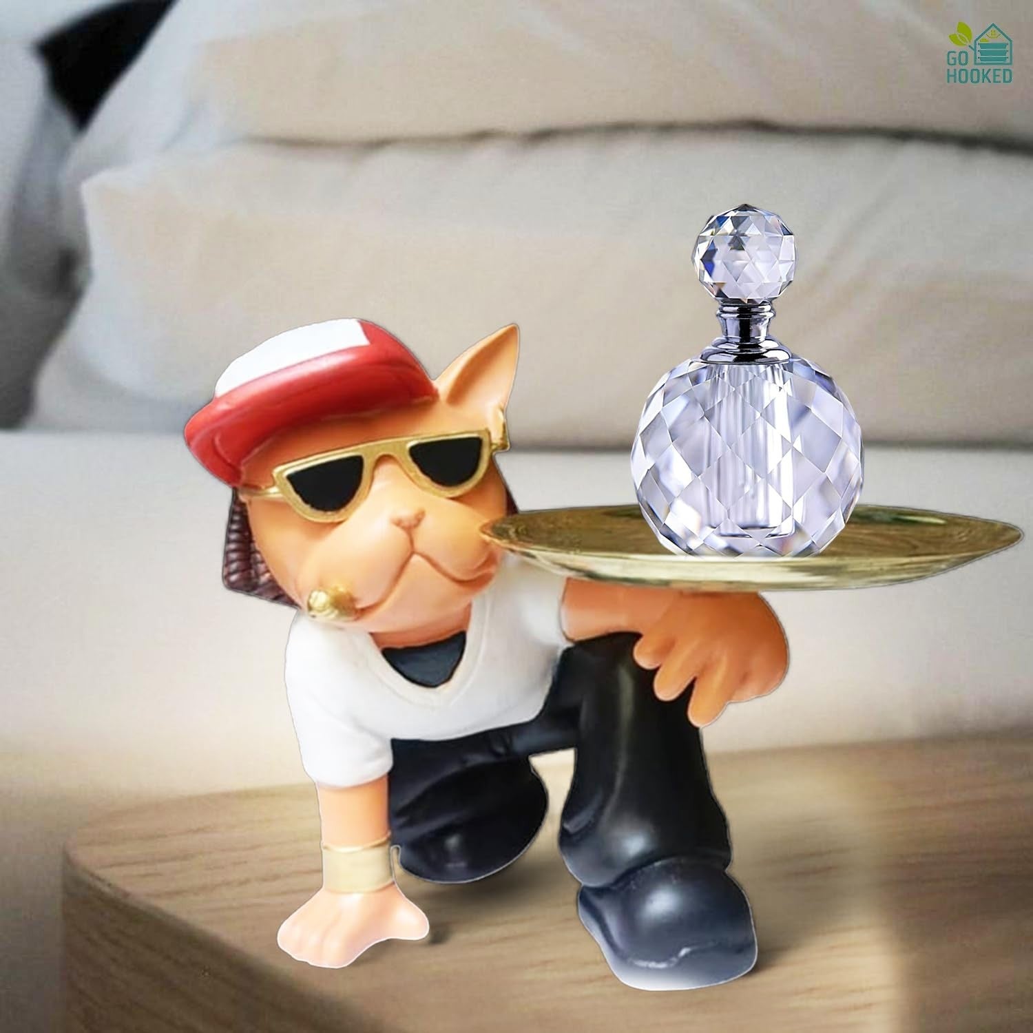 Go Hooked cat figurine in sunglasses and hat holding a golden tray with a crystal bottle. Black and white.