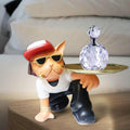GoHooked black and white cat figurine wearing sunglasses and a hat, holding a gold tray with a crystal bottle.