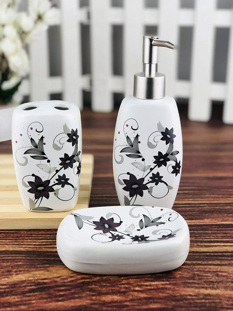 GoHooked 3-piece ceramic bathroom set with floral design. Includes soap dispenser, toothbrush holder, and soap dish in white with black and purple accents.