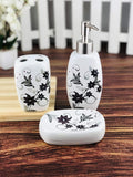 GoHooked white ceramic 3-piece bathroom set with black floral design, includes soap dispenser, toothbrush holder, and soap dish.