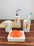 Go Hooked 4-piece ceramic bathroom set with a colorful abstract geometric pattern. Includes soap dispenser, tumbler, toothbrush holder, and soap dish.
