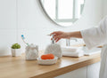 GoHooked white ceramic 3-piece bathroom set with rose detailing, including soap dispenser, toothbrush holder, and soap dish.