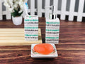 Go Hooked 3-piece ceramic bathroom set with toothbrush holder, soap dispenser, and soap dish in a striped design.