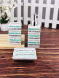 Go Hooked 3-piece ceramic bathroom set with toothbrush holder, soap dispenser, and soap dish in a modern striped design.