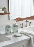 Go Hooked 3-piece ceramic bathroom set with a toothbrush holder, soap dispenser, and soap dish, featuring a striped pattern in teal, gray, and white.