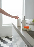 Go Hooked white ceramic bathroom set with dispenser, toothbrush holder, and soap dish. Modern design.