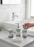 GoHooked 4-piece ceramic bathroom set with purple base, featuring floral and striped patterns in pastel colors.