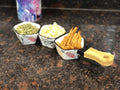 GoHooked white ceramic snack serving tray with bamboo handle, holding fries, pumpkin seeds, and popcorn.
