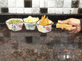 GoHooked white ceramic snack serving tray with three compartments, holding pumpkin seeds, corn, and french fries.