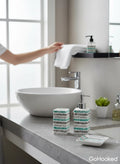 GoHooked 3-piece ceramic bathroom set with a striped design in teal, grey, and white. Includes soap dispenser, toothbrush holder, and soap dish.