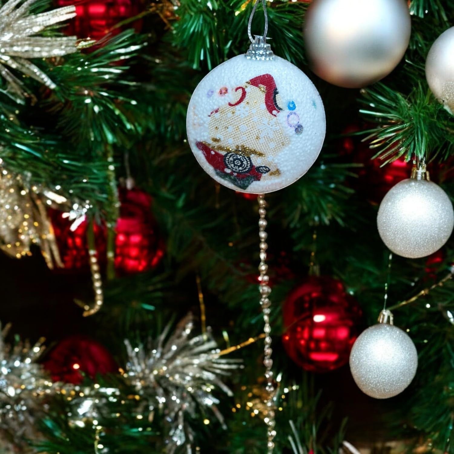 GoHooked multicolor Christmas ornament ball with Santa design, glitter accents, and hanging loop. Festive decor.