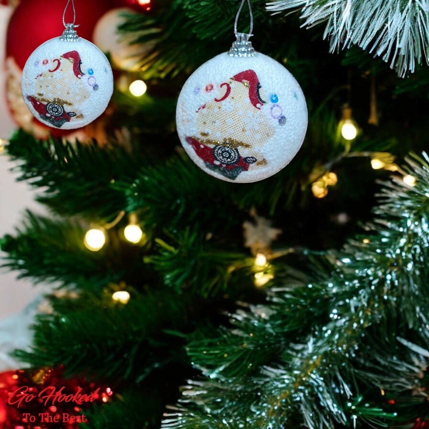 Go Hooked white Christmas ornament balls with Santa Claus design and glitter accents, hanging on a decorated tree.