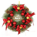 GoHooked Christmas wreath with red bows, pinecones, red berries, and "Feliz Navidad" text.