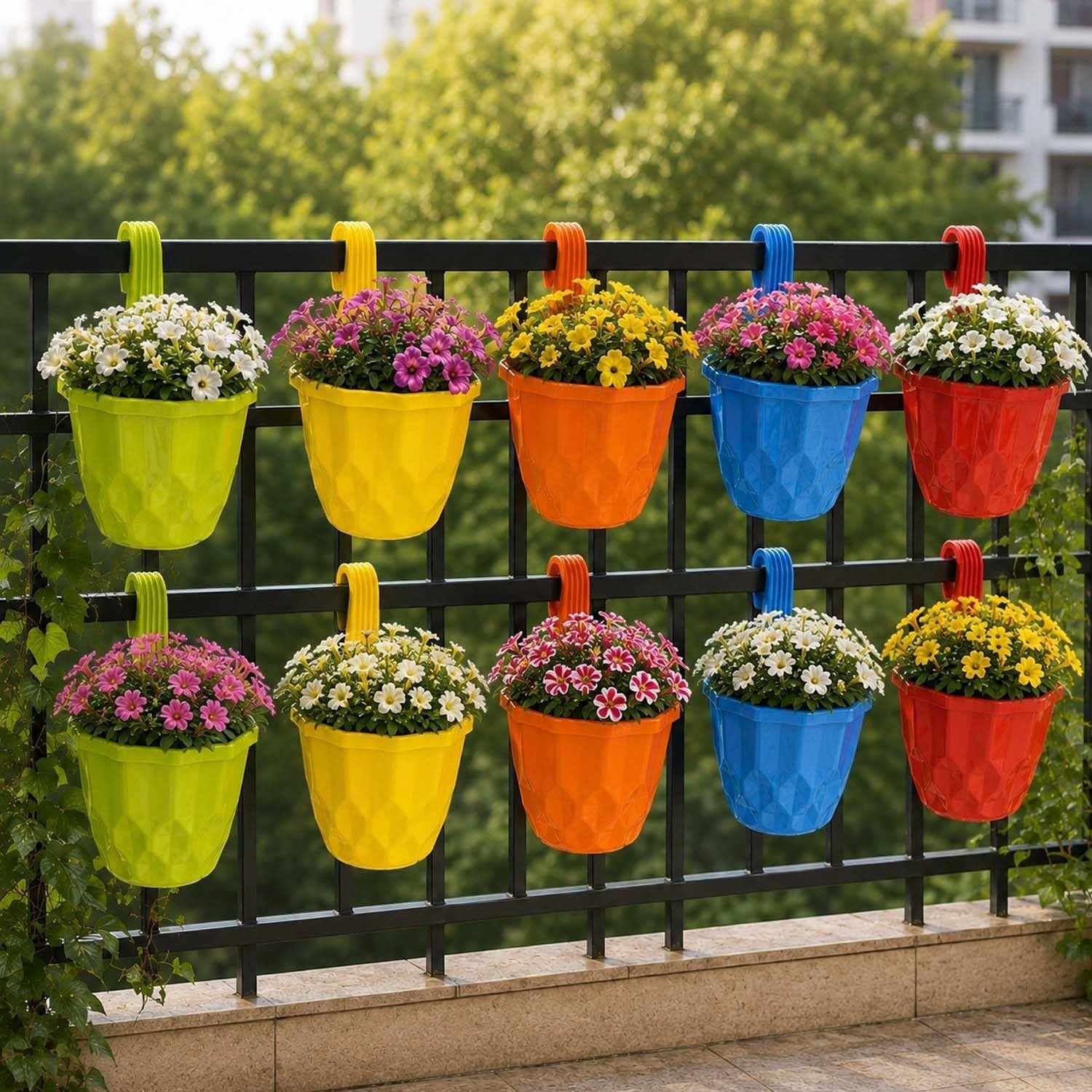 GoHooked set of 10 colorful geometric plastic hanging planter pots displayed on a black balcony railing with flowers