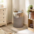 GoHooked two-tone brown and beige cotton rope laundry basket with sturdy handles in a cozy bedroom setting
