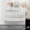 GoHooked cotton rope laundry basket in grey and white with sturdy handles for easy carrying in a nursery or bedroom.