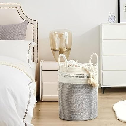 GoHooked two-tone grey and white cotton rope laundry basket with sturdy handles in a modern bedroom setting
