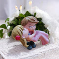 Go Hooked romantic couple figurine of groom carrying bride in pink dress, resin, for cake decoration or home decor.