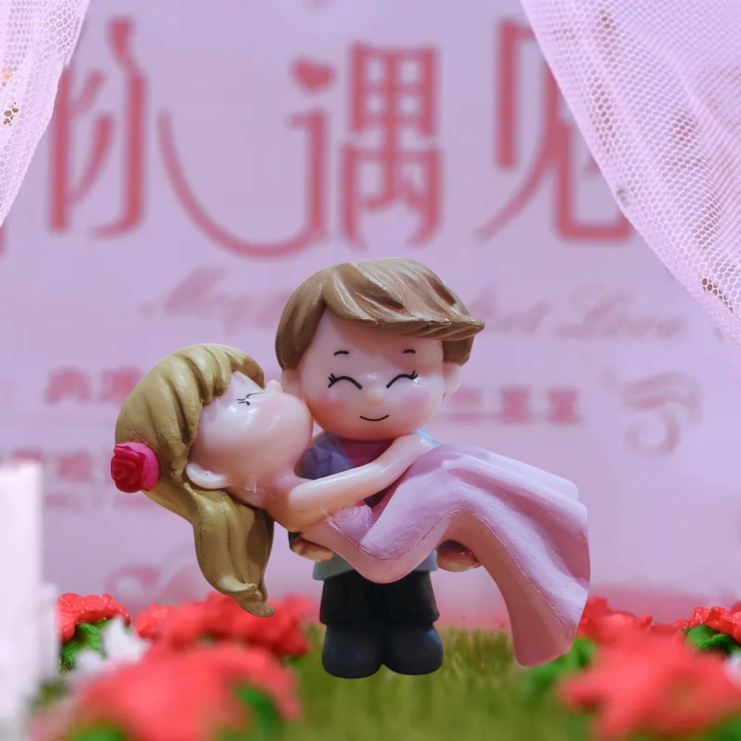 GoHooked romantic couple figurine of groom carrying bride, both in pink, for cake decoration or home decor.