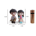 Go Hooked romantic couple figurines, boy in white shirt and brown pants, girl in blue dress holding pink cup. Resin, 4cm tall.