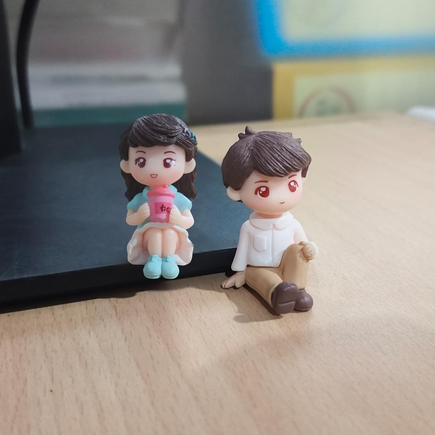 GoHooked romantic couple figurines, girl in blue dress holding pink drink, boy in white shirt and brown pants sitting. Resin material.