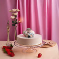 Go Hooked romantic bride and groom figurines in black and white, kissing on a cake. Made of resin.