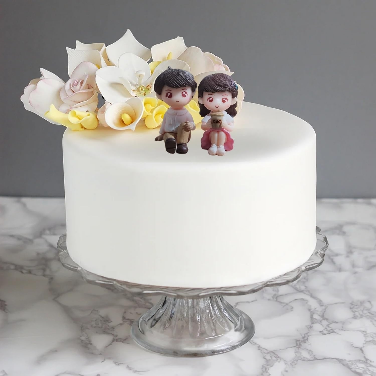 GoHooked romantic couple figurines sitting on a white cake with pink dress doll holding a coffee cup. Resin material.
