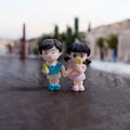 GoHooked resin couple figurines of kids holding ice cream, boy in blue shirt, girl in pink dress.