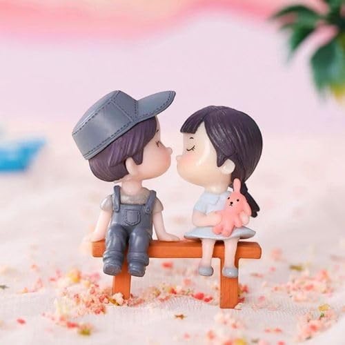 GoHooked resin couple figurines kissing on a bench, holding a pink bunny. Romantic decor for cakes or home.