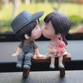 GoHooked romantic couple figurines kissing on a bench, boy wears cap and overalls, girl holds bunny. Resin.