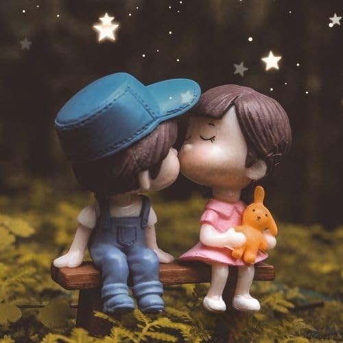 GoHooked resin couple figurines kissing on a bench, boy in blue overalls, girl in pink dress holding a bunny. Romantic decor.