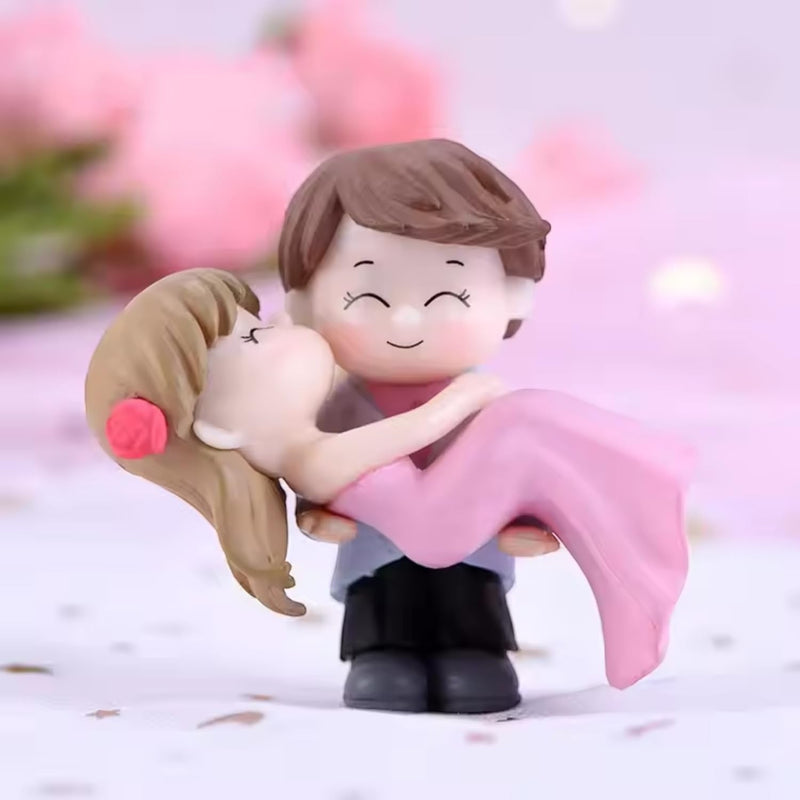 GoHooked romantic couple figurines, bride in pink dress being carried by groom, resin material, perfect for cake decoration or home decor.